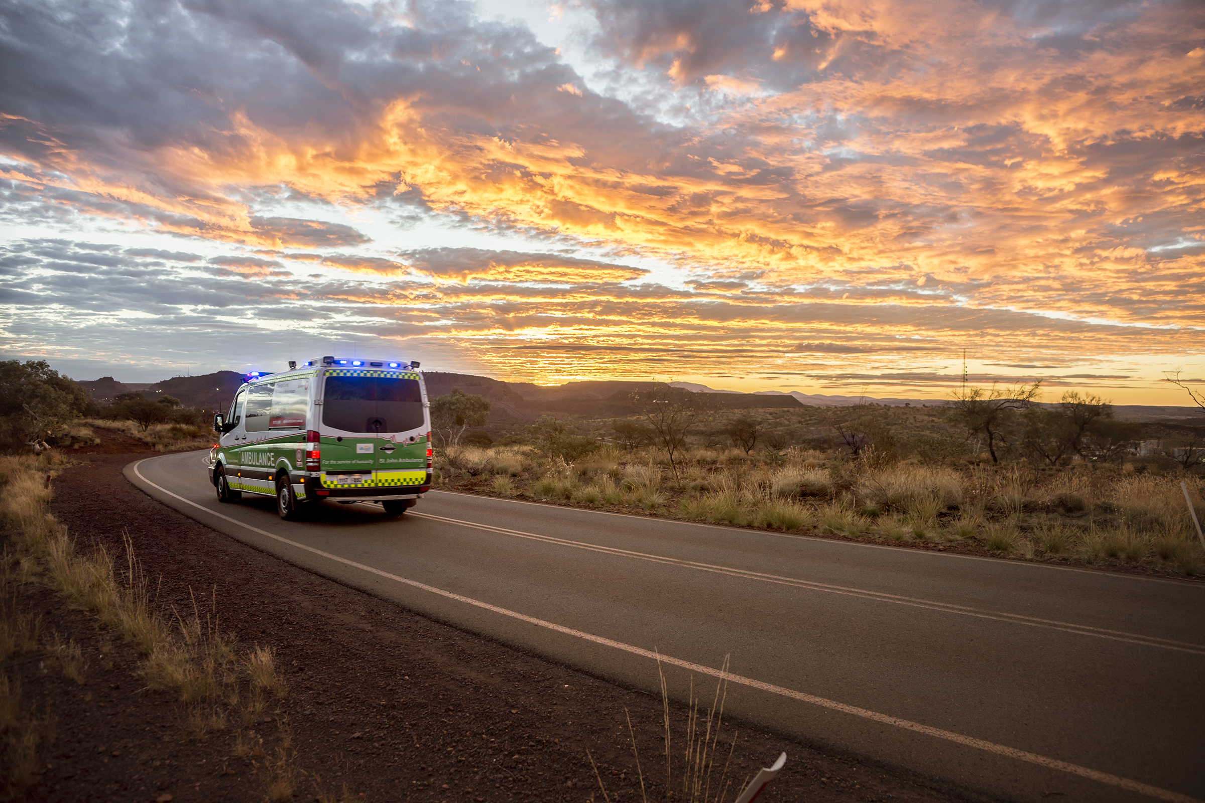 Ambulance driving along rural road